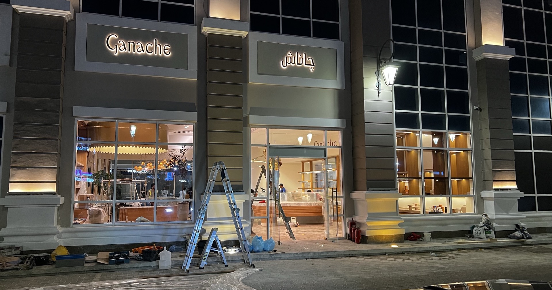 Illuminated bilingual shopfront and signage installed at night on a Dar Anan retail fit-out in Riyadh